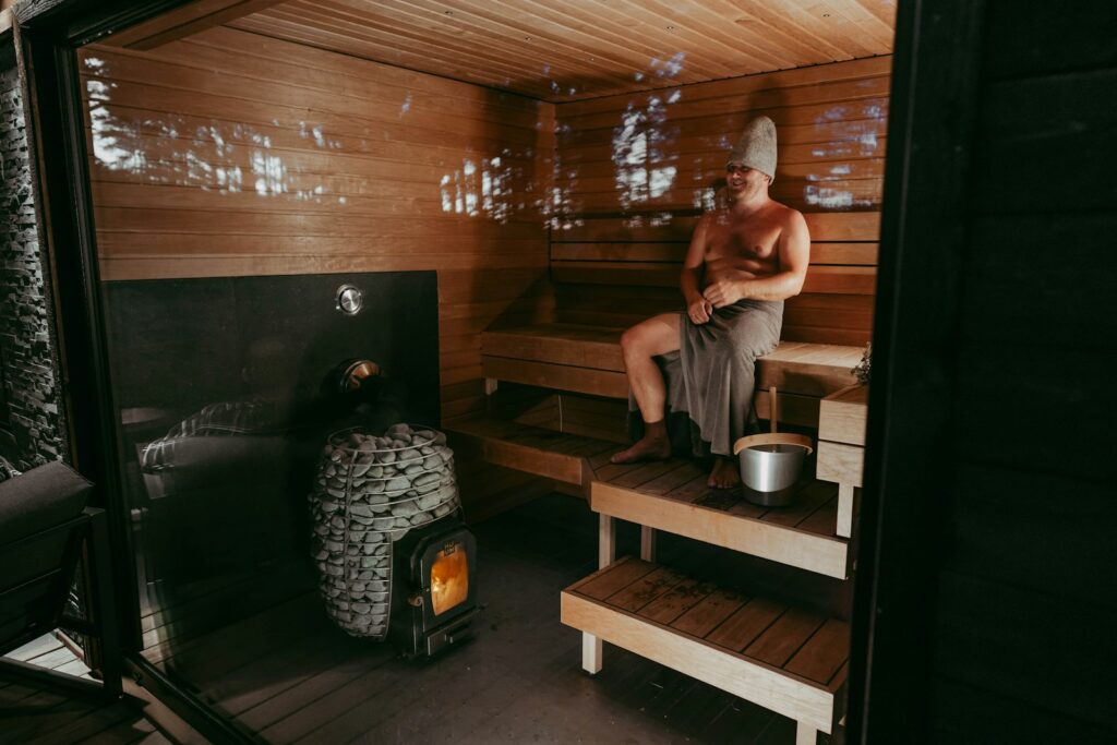 Homme assis dans un sauna en bois