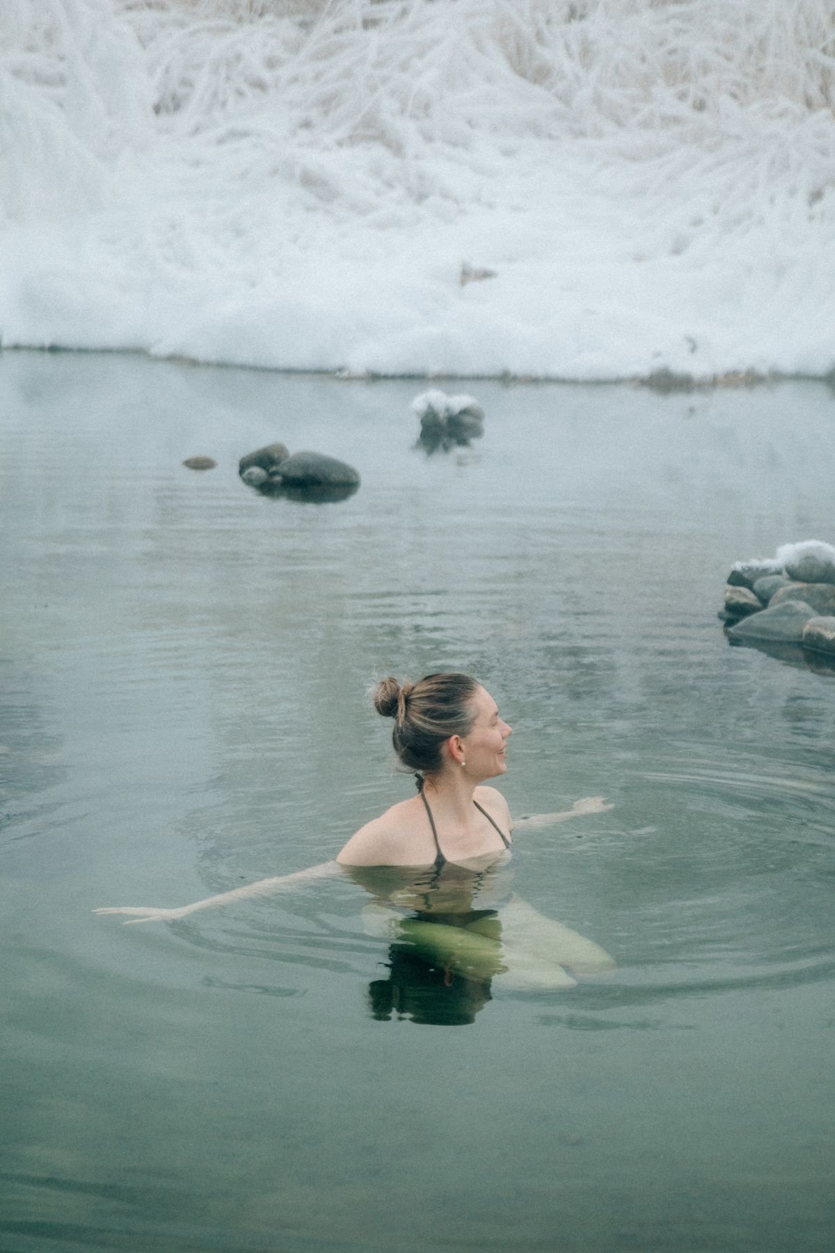 Femme en immersion dans un lac enneigé